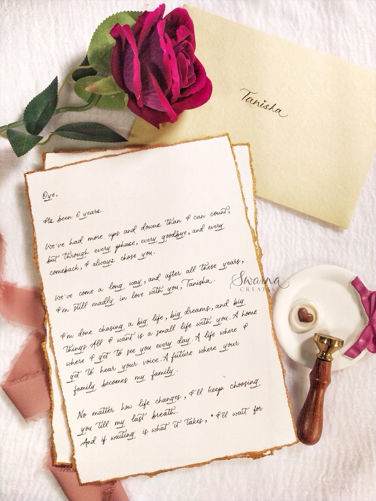 Handwritten love letter on aged paper with a red rose and wax seal.