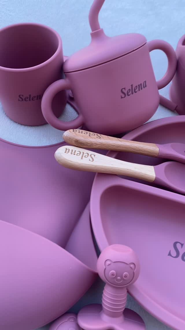 Mauve silicone baby feeding set with personalized cup, plate, and wooden spoons.
