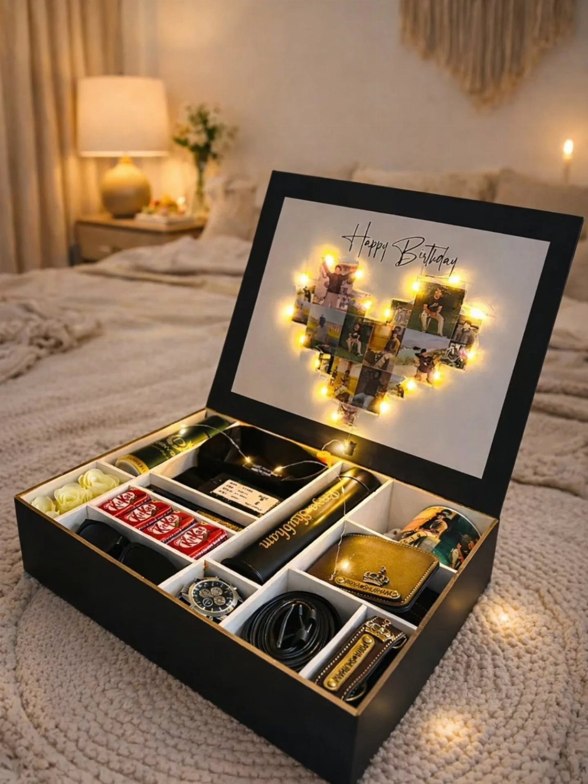 Black birthday gift box with accessories and a heart-shaped photo collage with lights.