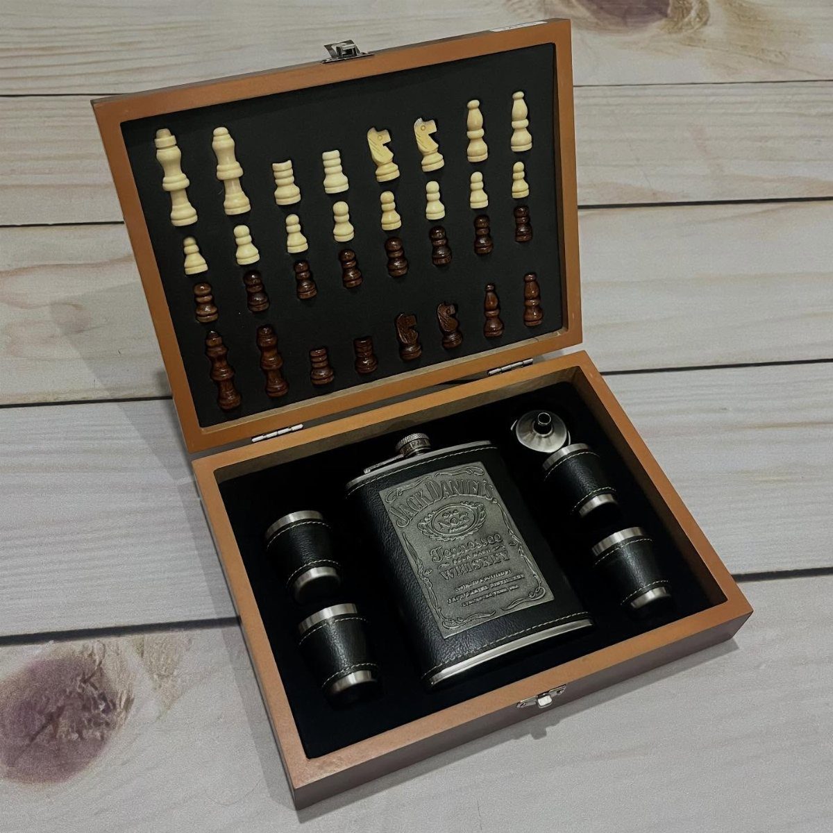 Wooden gift set containing a chess set, engraved hip flask, and two shot glasses.