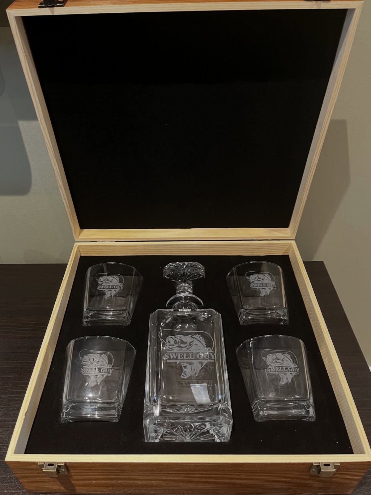 Glass decanter and four matching glasses in a wooden gift box with velvet lining