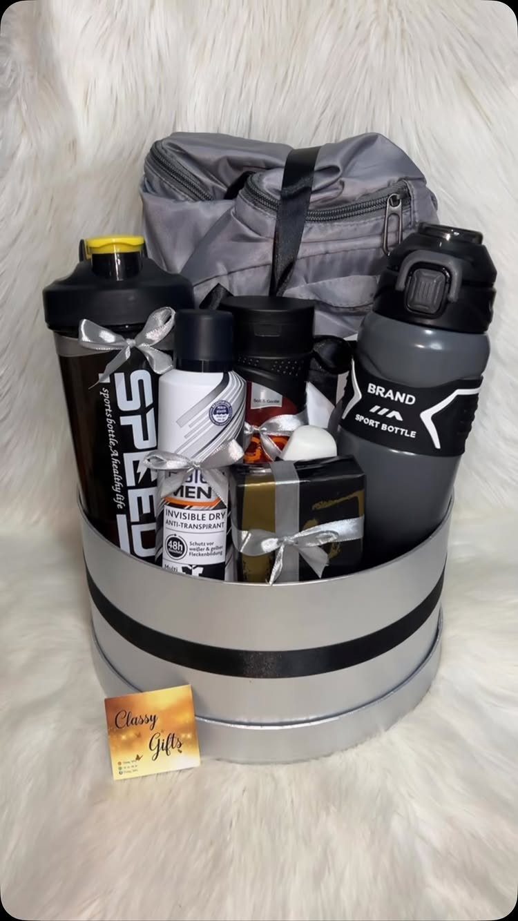 Gift basket for men with gym bag, water bottles, and grooming products.