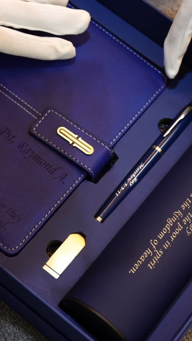 Blue gift set with embossed notebook, pen, and container in a blue box