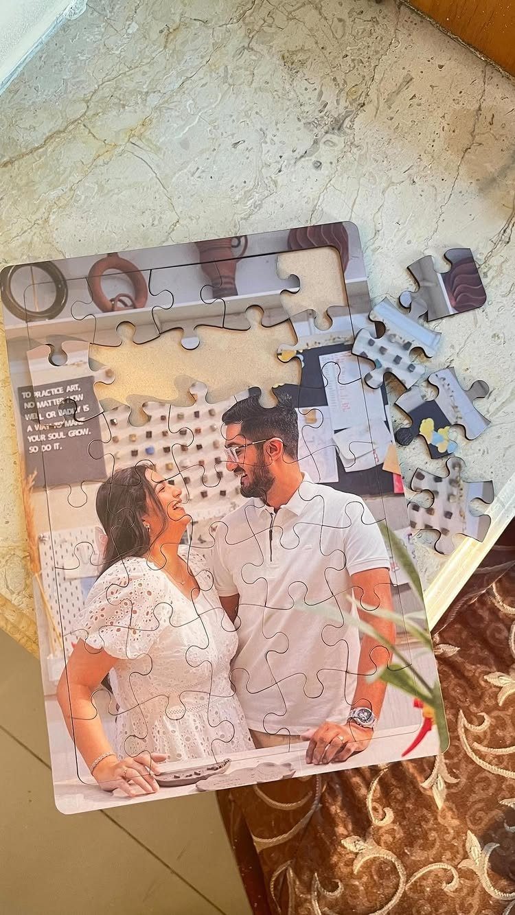 Partially completed custom jigsaw puzzle showing a couple smiling at each other.