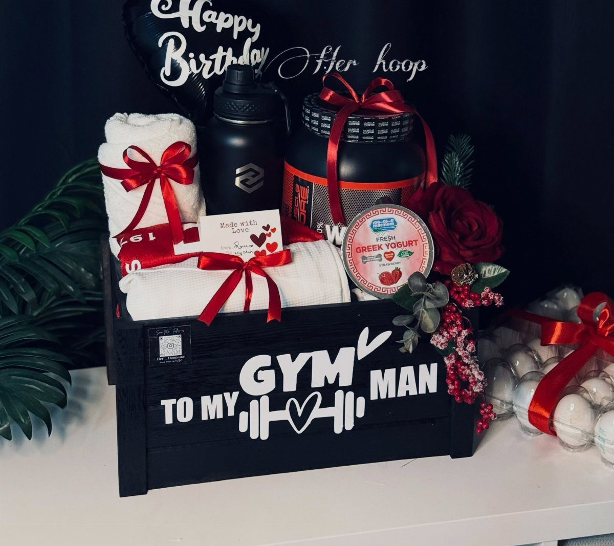 Gym themed gift basket in a black wooden crate with fitness accessories