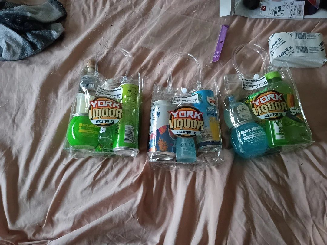 Three clear plastic gift bags containing mini liquor bottles and colorful mixers.