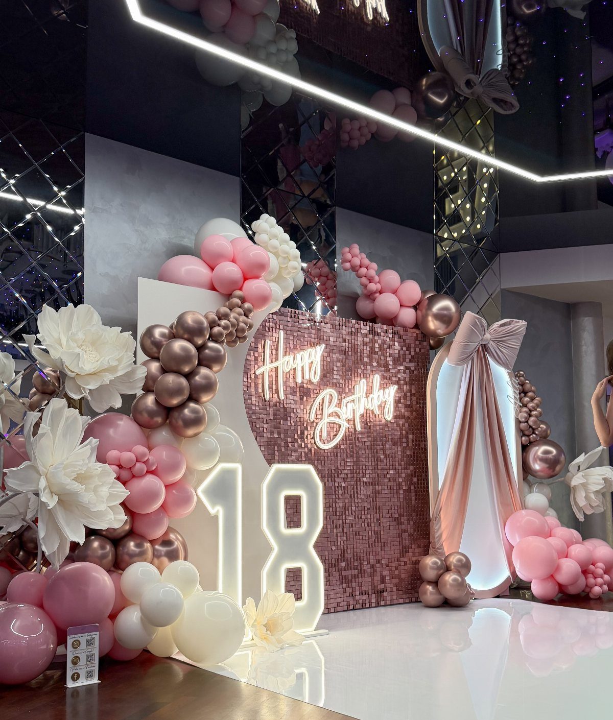 Glowing number 18 and rose gold sequin backdrop with pink and gold balloons.