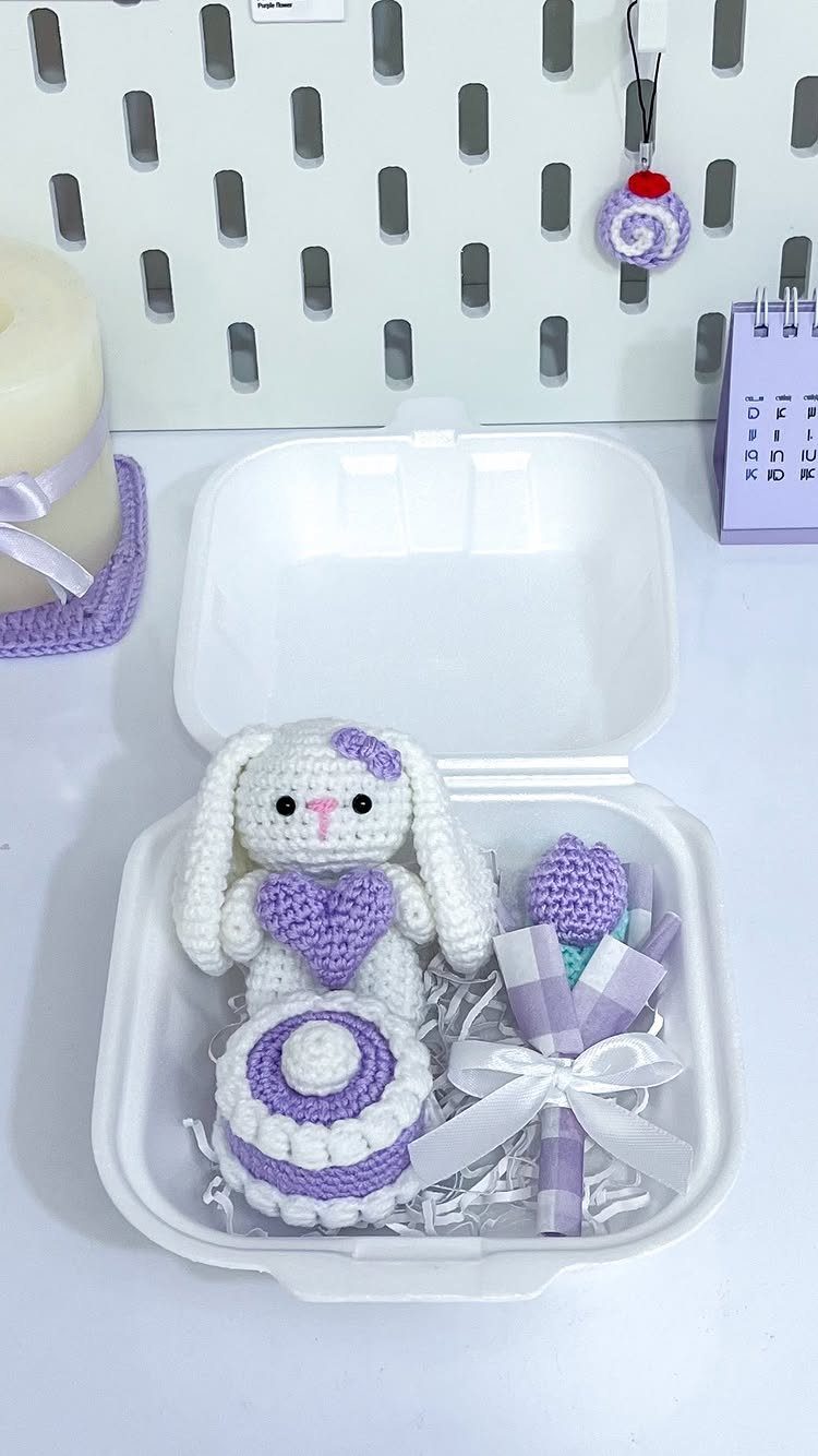 Crocheted bunny, cake, and flower in a white gift box for a friend.