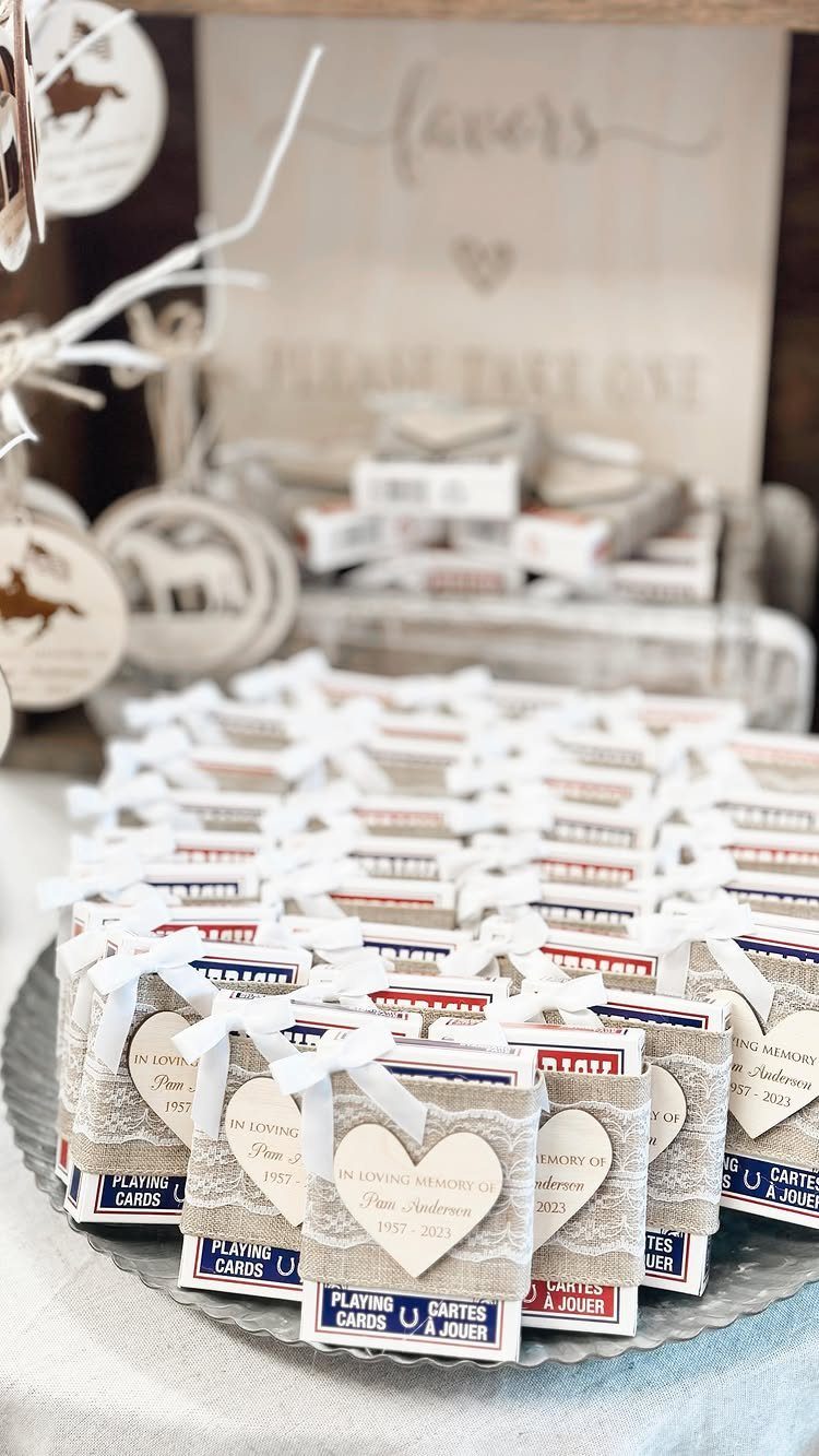 Playing card favors wrapped in burlap and white ribbons with heart-shaped wooden tags.