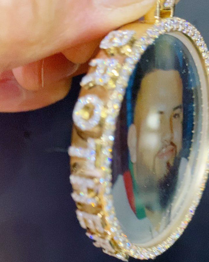 Gold oval memorial pendant with a man's photo and jeweled BROTHER lettering.