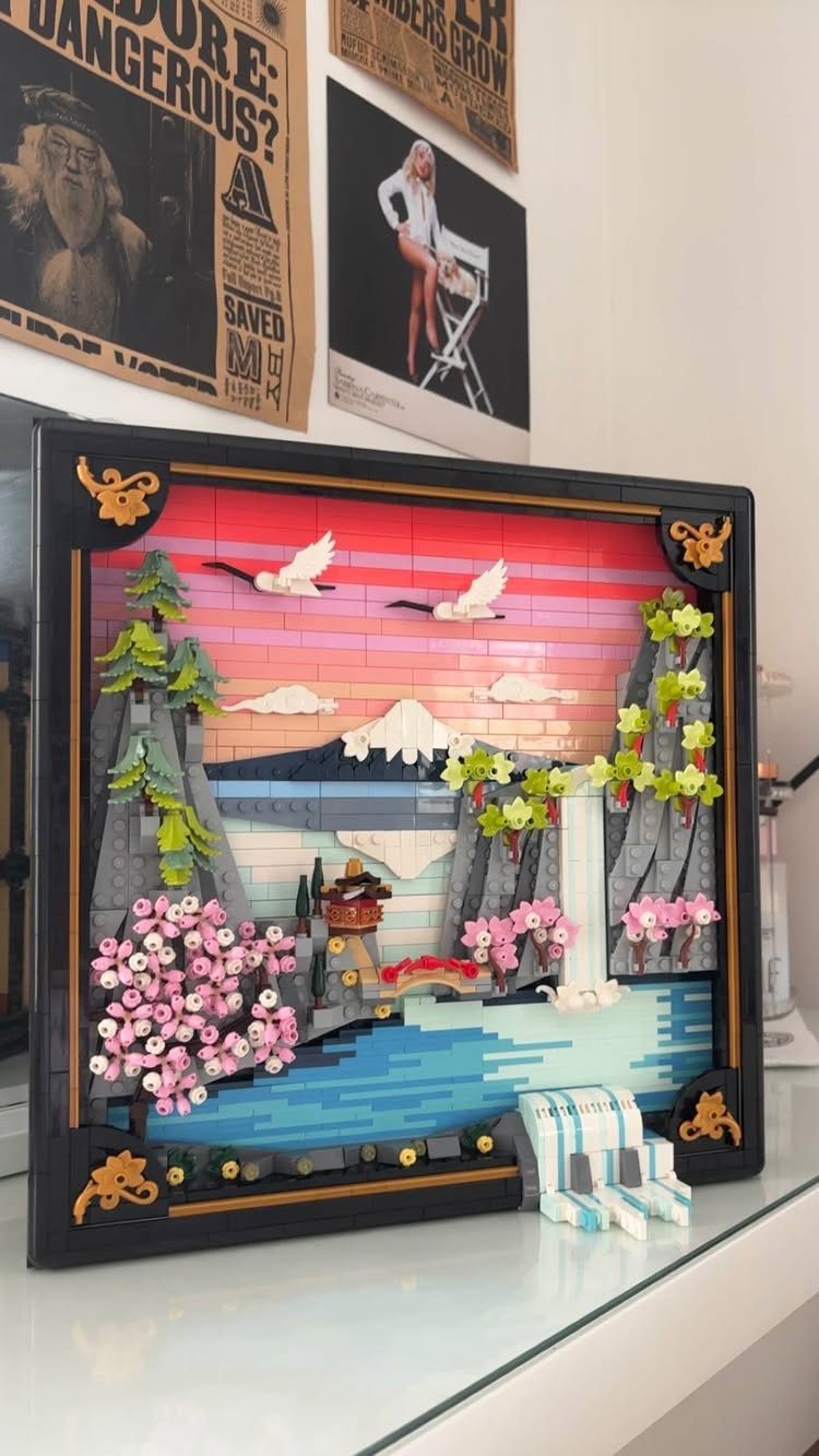 LEGO art piece of a Japanese landscape with cherry blossoms and a mountain.