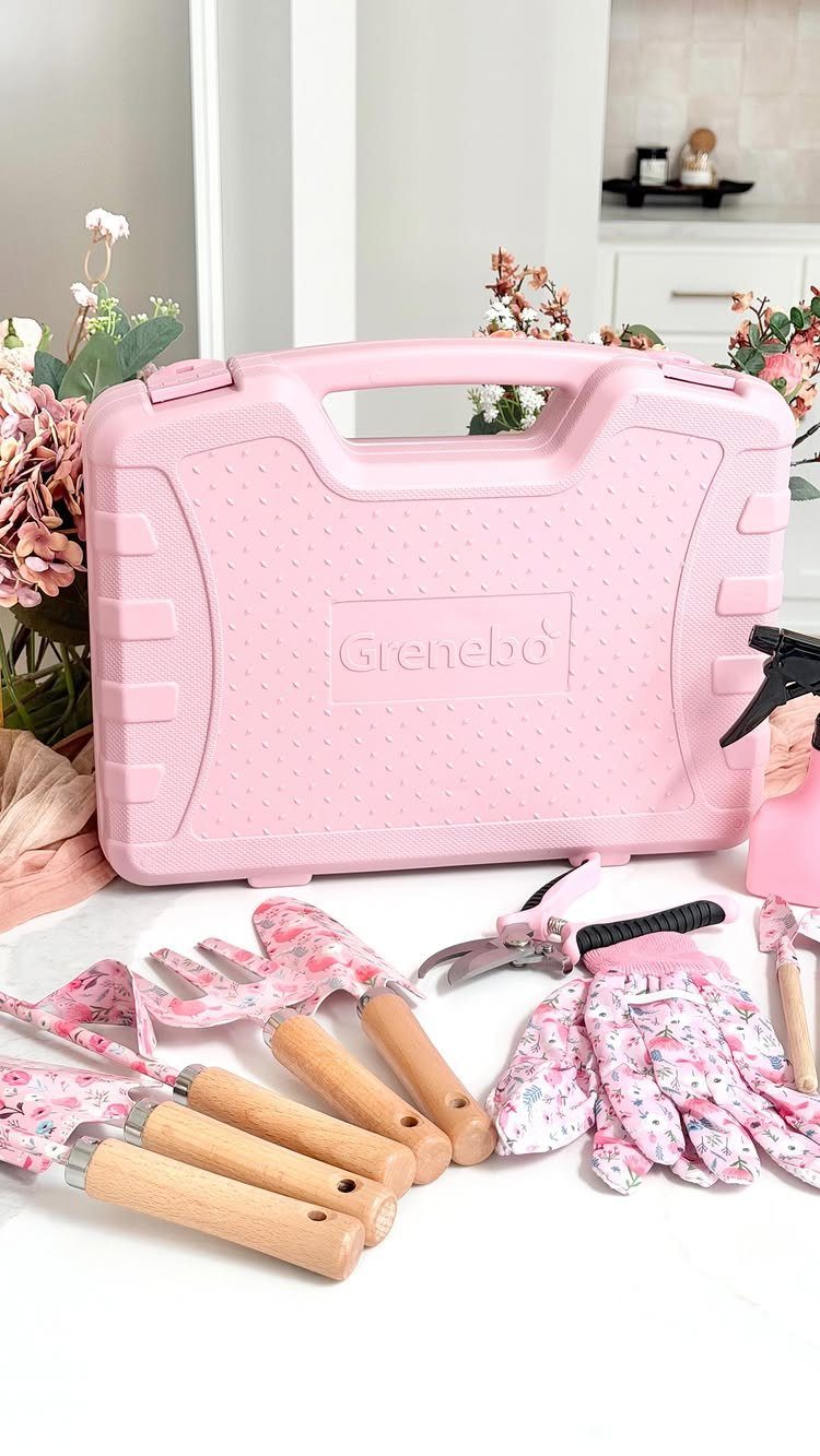 Pink gardening tool set with floral gloves and a matching plastic carrying case.