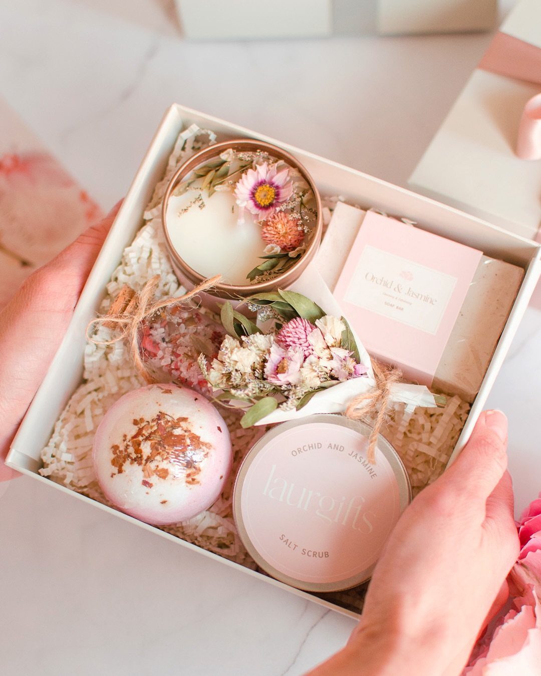 Spa gift set in a white box with bath bomb, scrub, and candle.