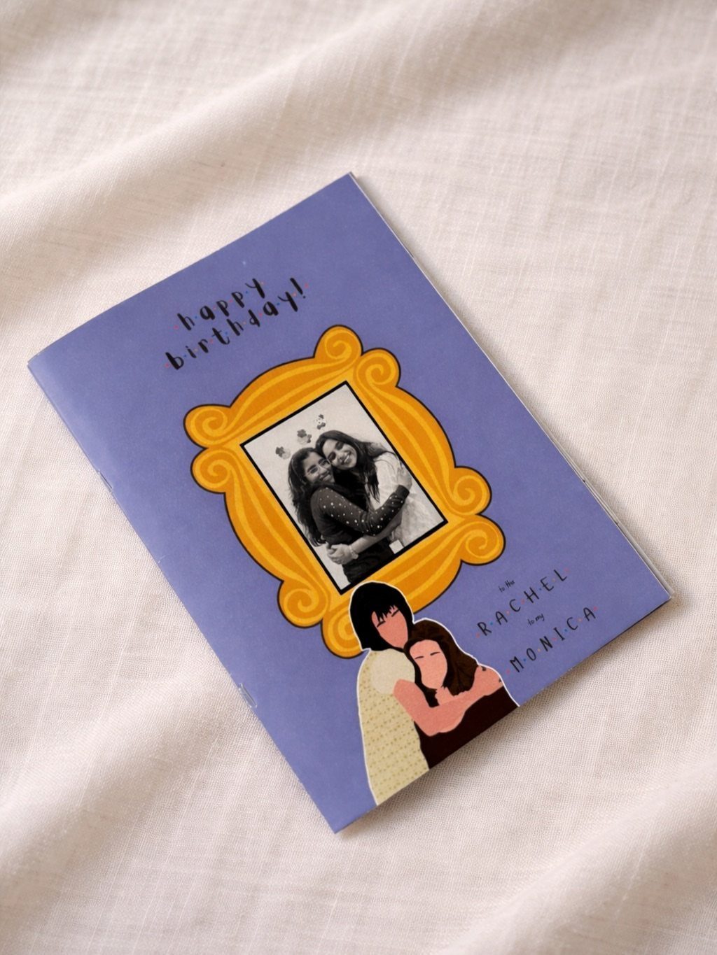 Purple birthday card with a framed photo and illustration of two female friends.