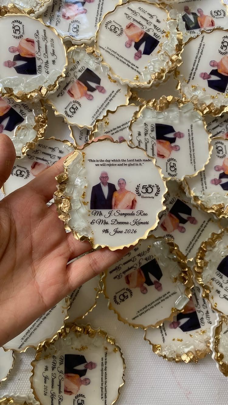 Resin coasters with gold edges featuring a couple's photo and 50th anniversary text.