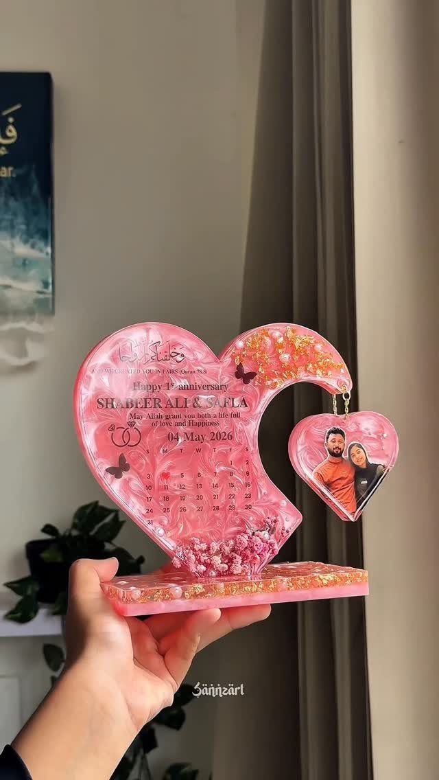 Pink resin heart anniversary plaque with gold glitter and a couple's photo charm.