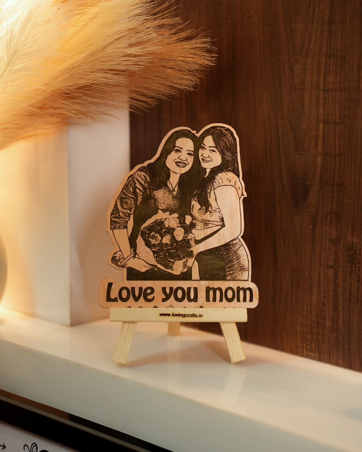 Wooden cutout of two women with Love you mom text on a mini easel