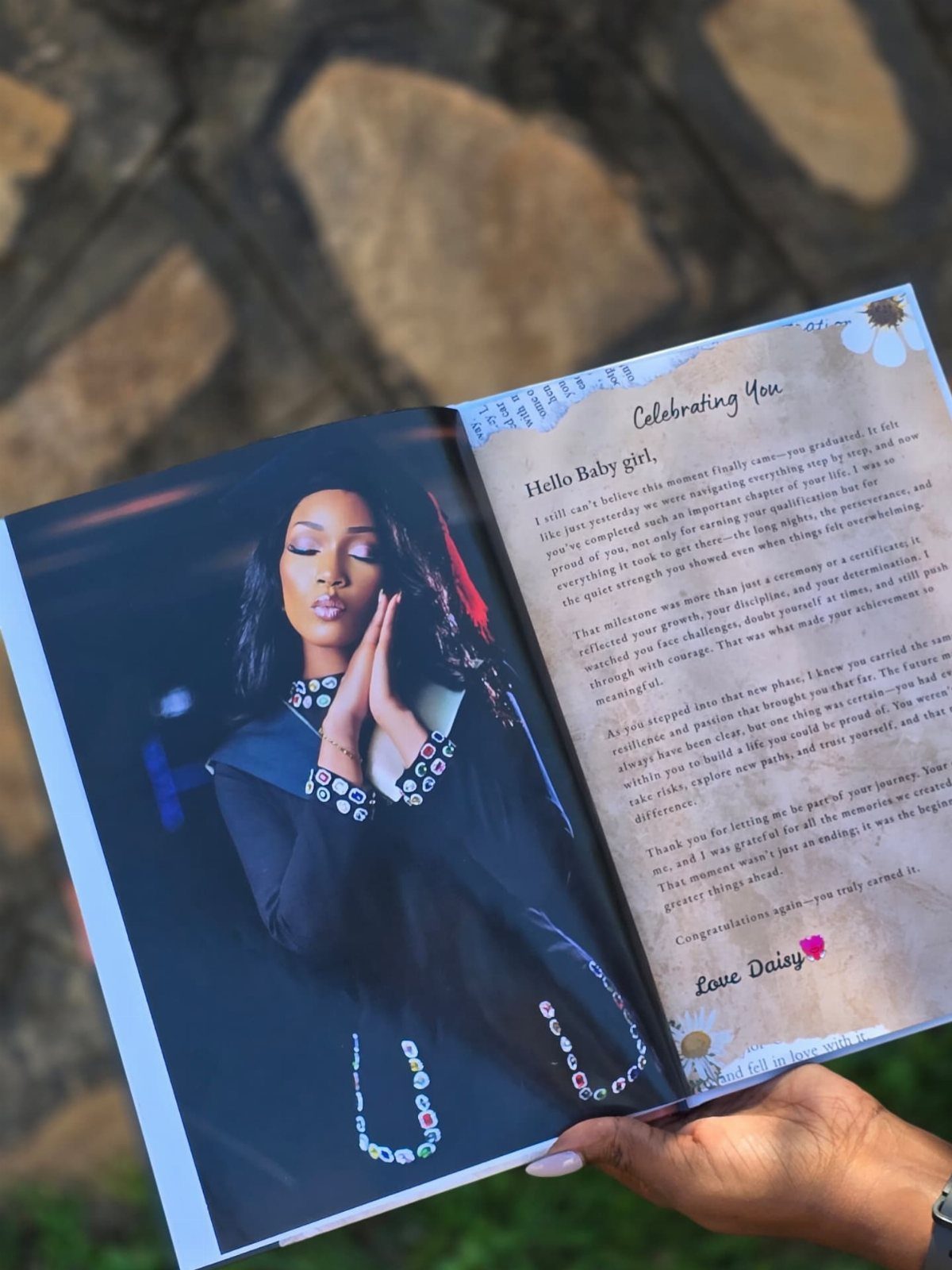 Open photo album showing a woman's portrait and a sentimental printed letter.