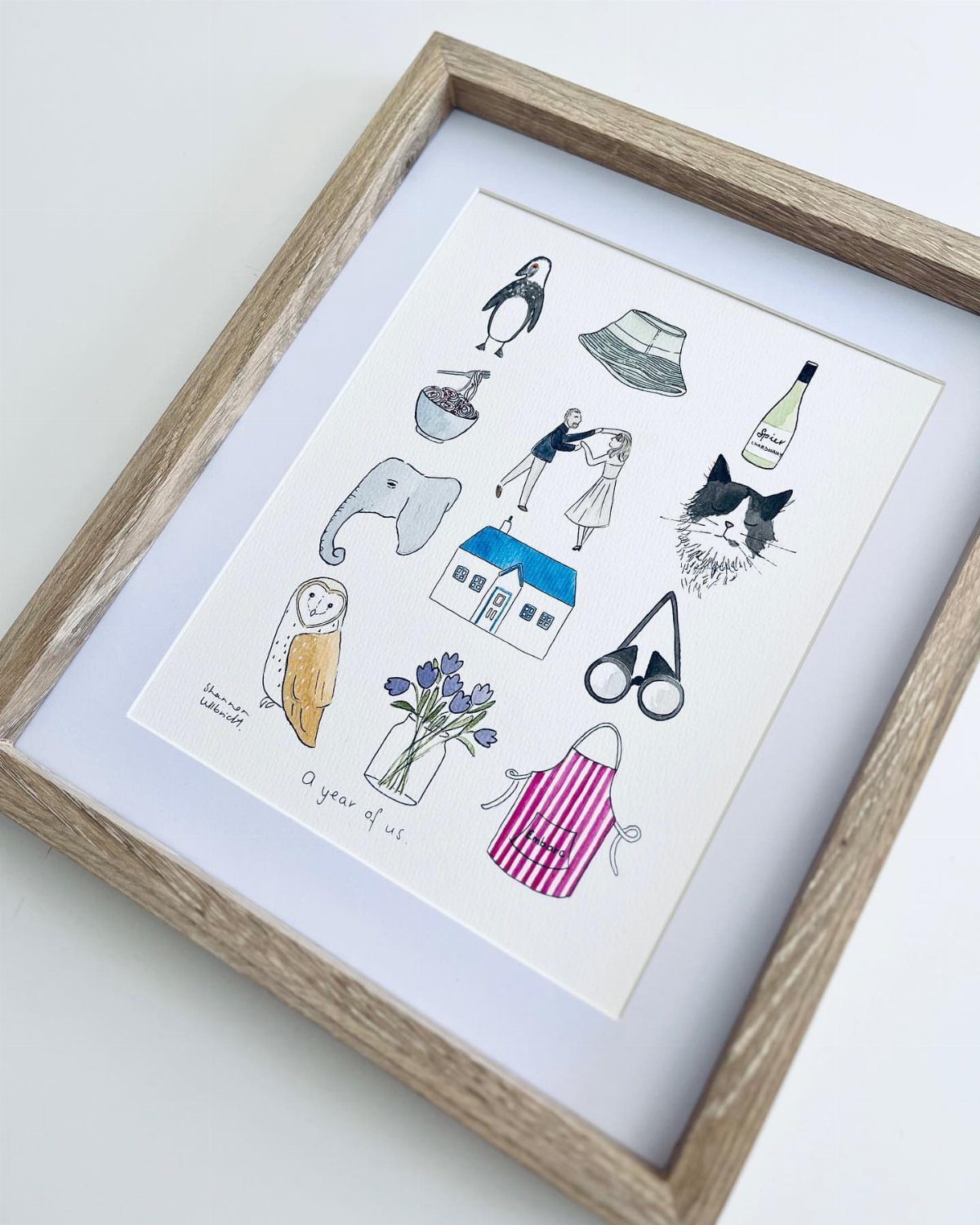 Framed illustration featuring small drawings of memories and the text a year of us