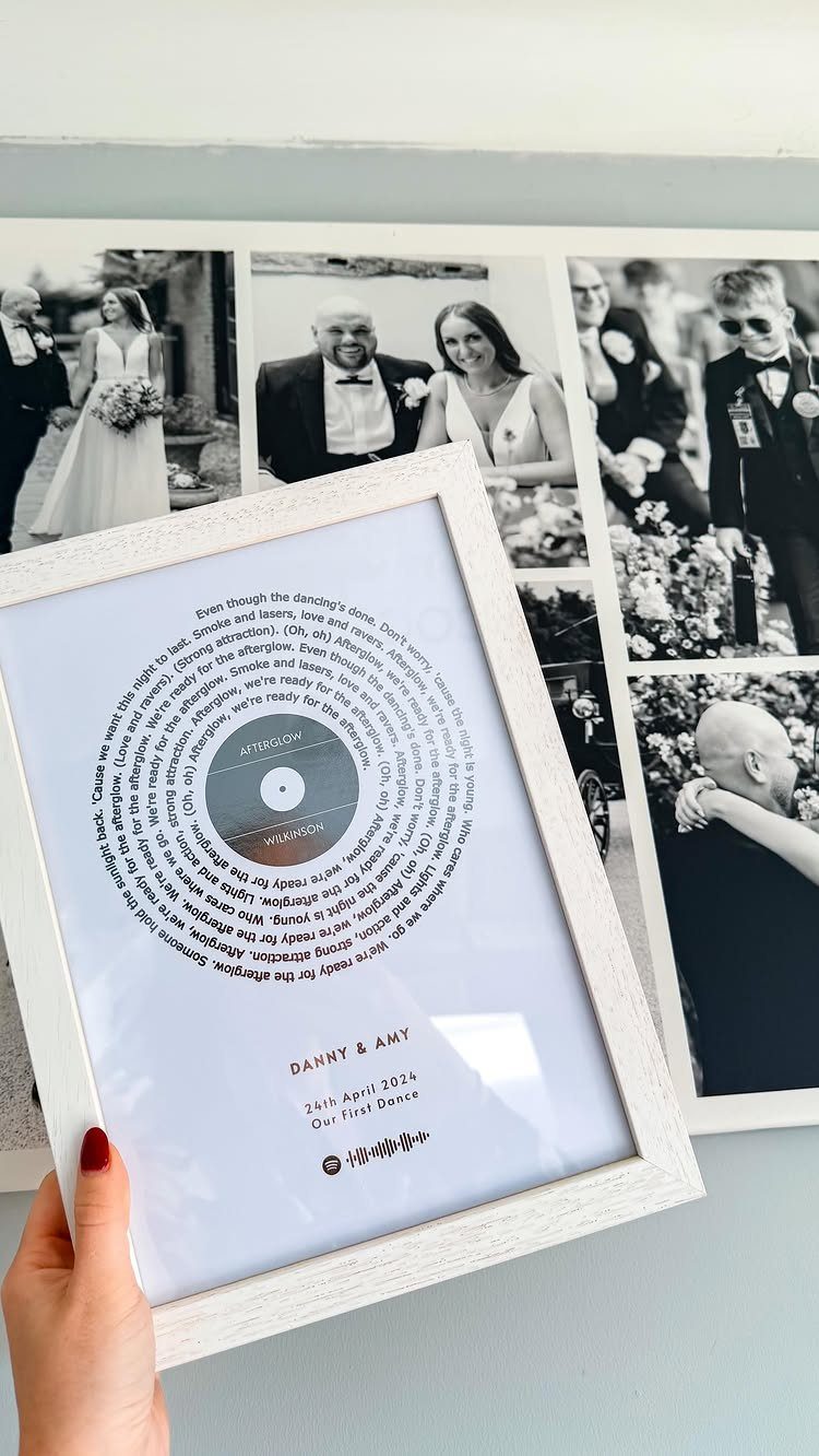 Framed song lyric print with vinyl record design held against wedding photo collage.