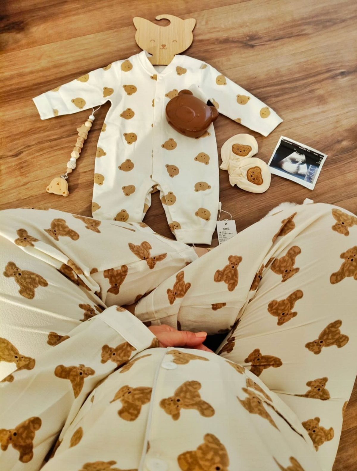 Matching cream and brown bear print pajamas for a parent and baby.
