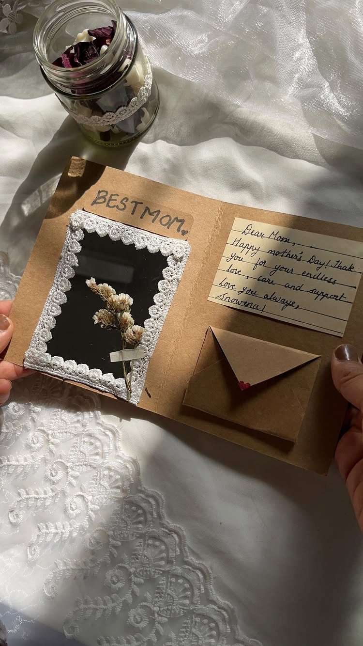 Handmade brown card with lace photo frame, dried flower, and handwritten note.