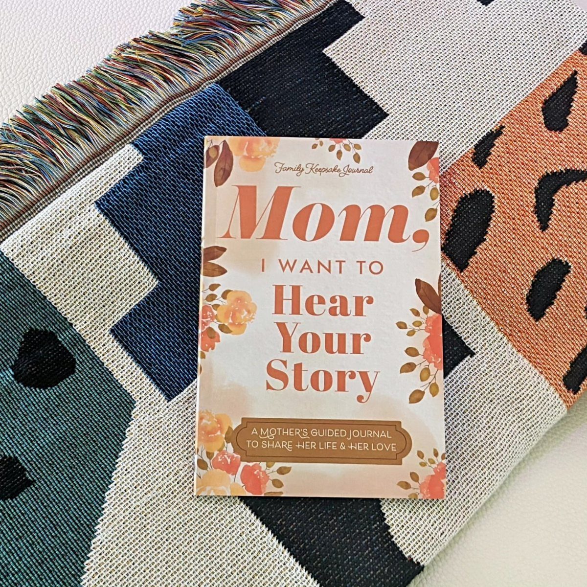 Guided journal for mothers titled Mom I Want to Hear Your Story on patterned fabric