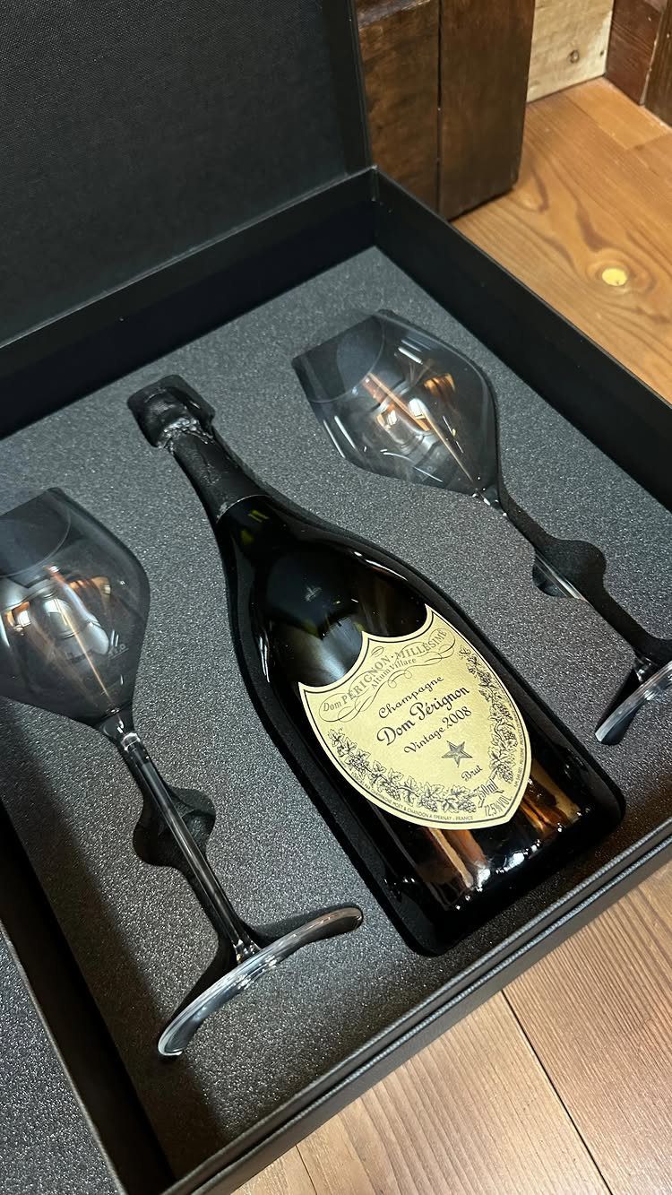 Champagne bottle and two black flutes in a luxury black gift box