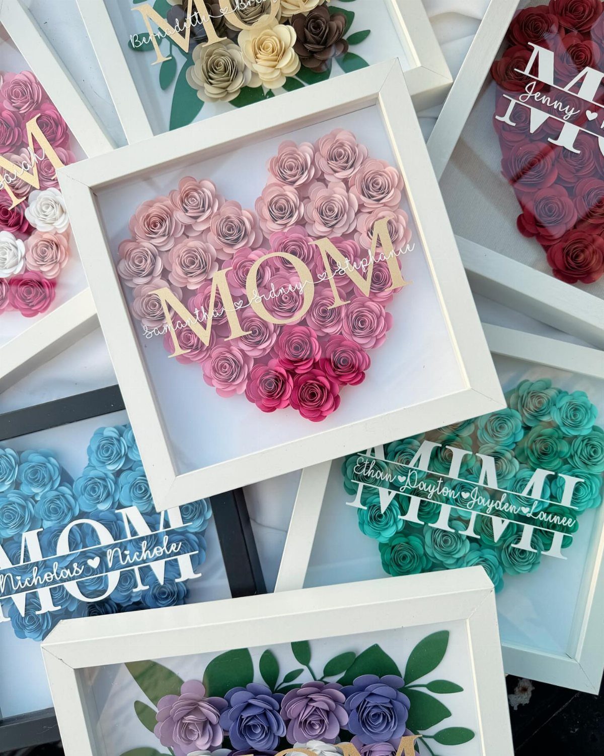 Framed heart-shaped paper rose arrangements with personalized gold and white lettering for Mom.