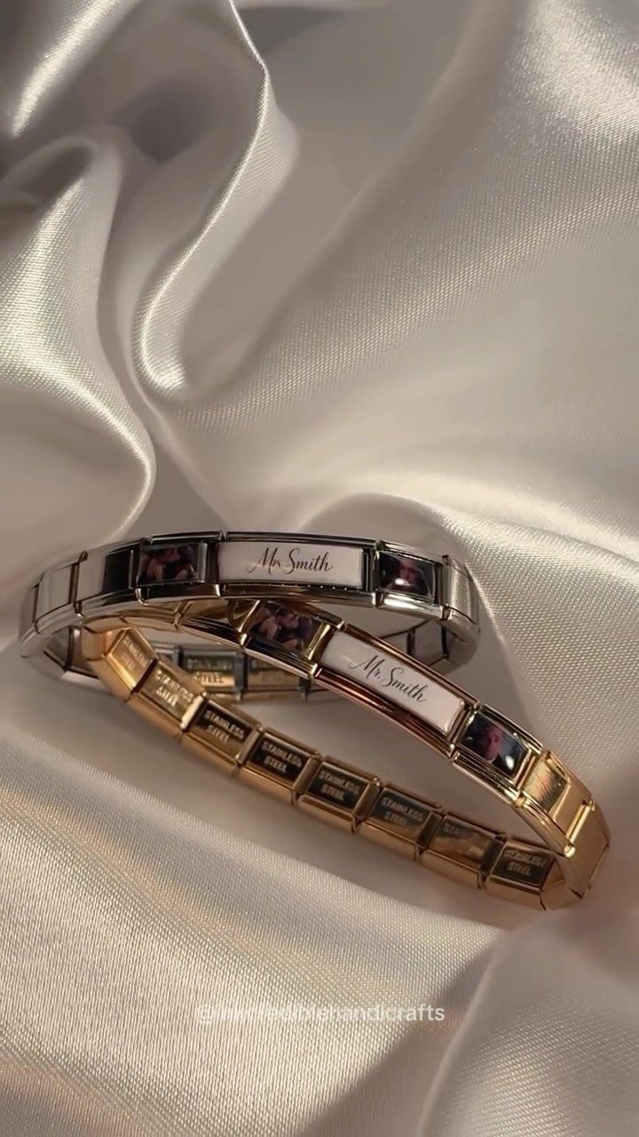 Two personalized photo bracelets in silver and gold on white satin fabric.