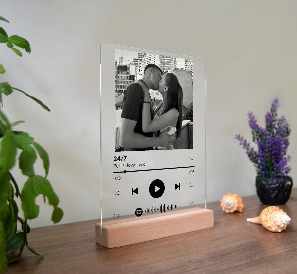 Customized Spotify acrylic plaque with a couple's photo on a wooden base.