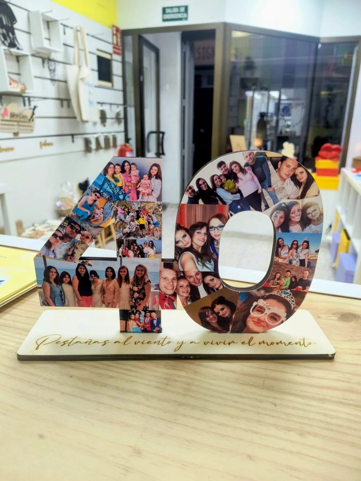 Wooden number 40 decorated with a photo collage on a wooden table