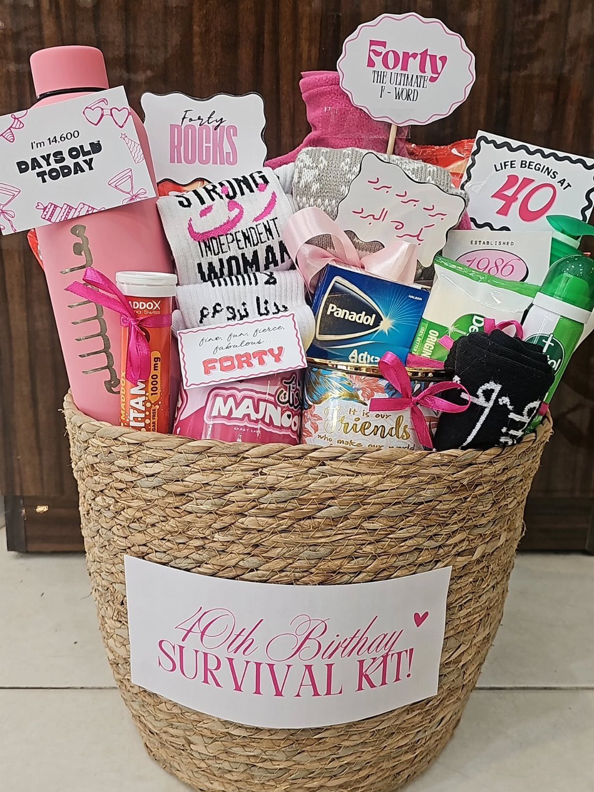 Woven gift basket filled with pampering items and a 40th Birthday Survival Kit label.