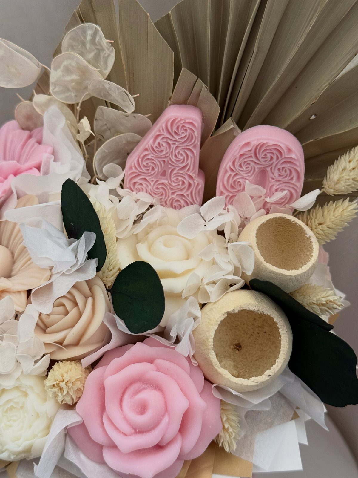 Soap roses and pink soap numbers 40 in a decorative floral arrangement.
