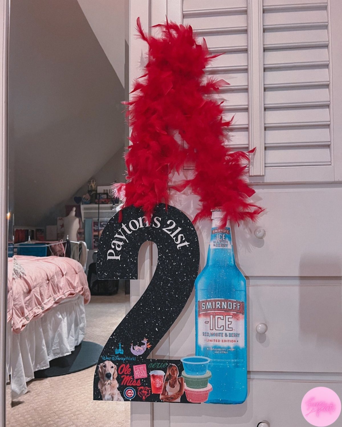 Black glittery number 2 cutout for a 21st birthday with red feathers.