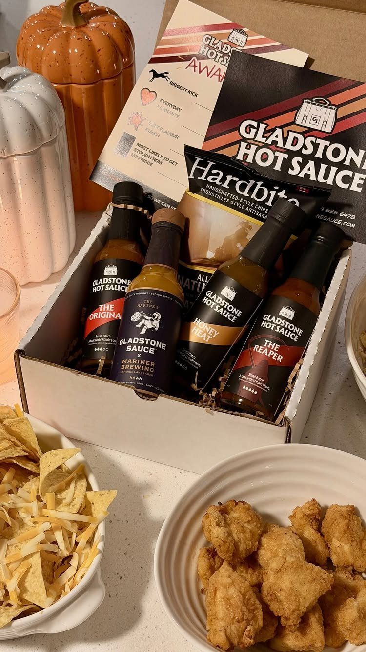 Hot sauce gift set in a box with chips and fried chicken snacks.