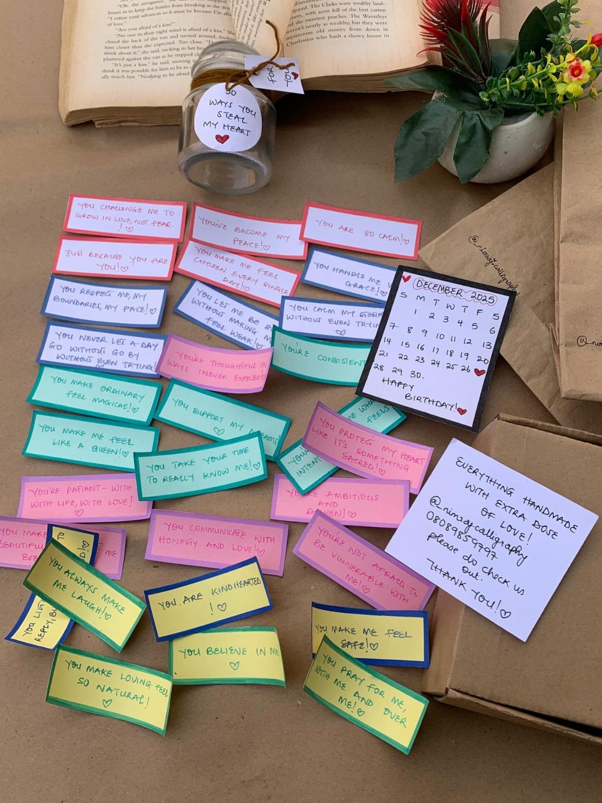 Glass jar and colorful handwritten memory notes scattered on a brown surface.