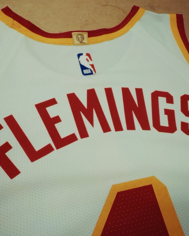 White NBA basketball jersey with the name FLEMINGS printed in red letters.