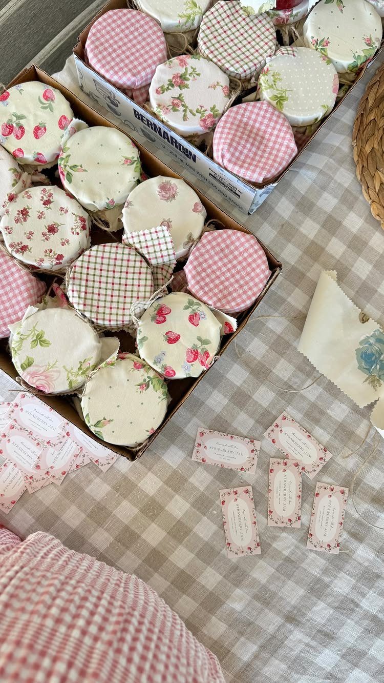 Small jars with fabric-covered lids and gift tags on a checkered tablecloth.