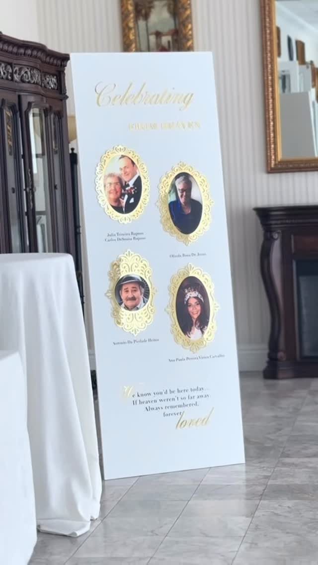 White memorial sign with gold text and four oval portraits of loved ones.
