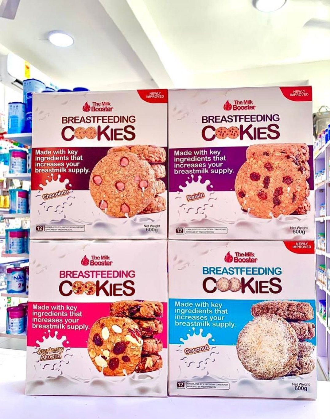 Four boxes of breastfeeding cookies in various flavors displayed on a store shelf.