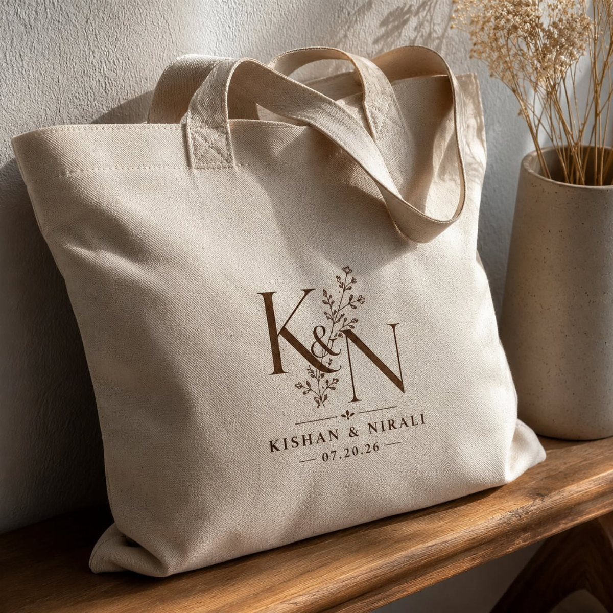 Beige canvas tote bag with personalized brown lettering on a wooden shelf.