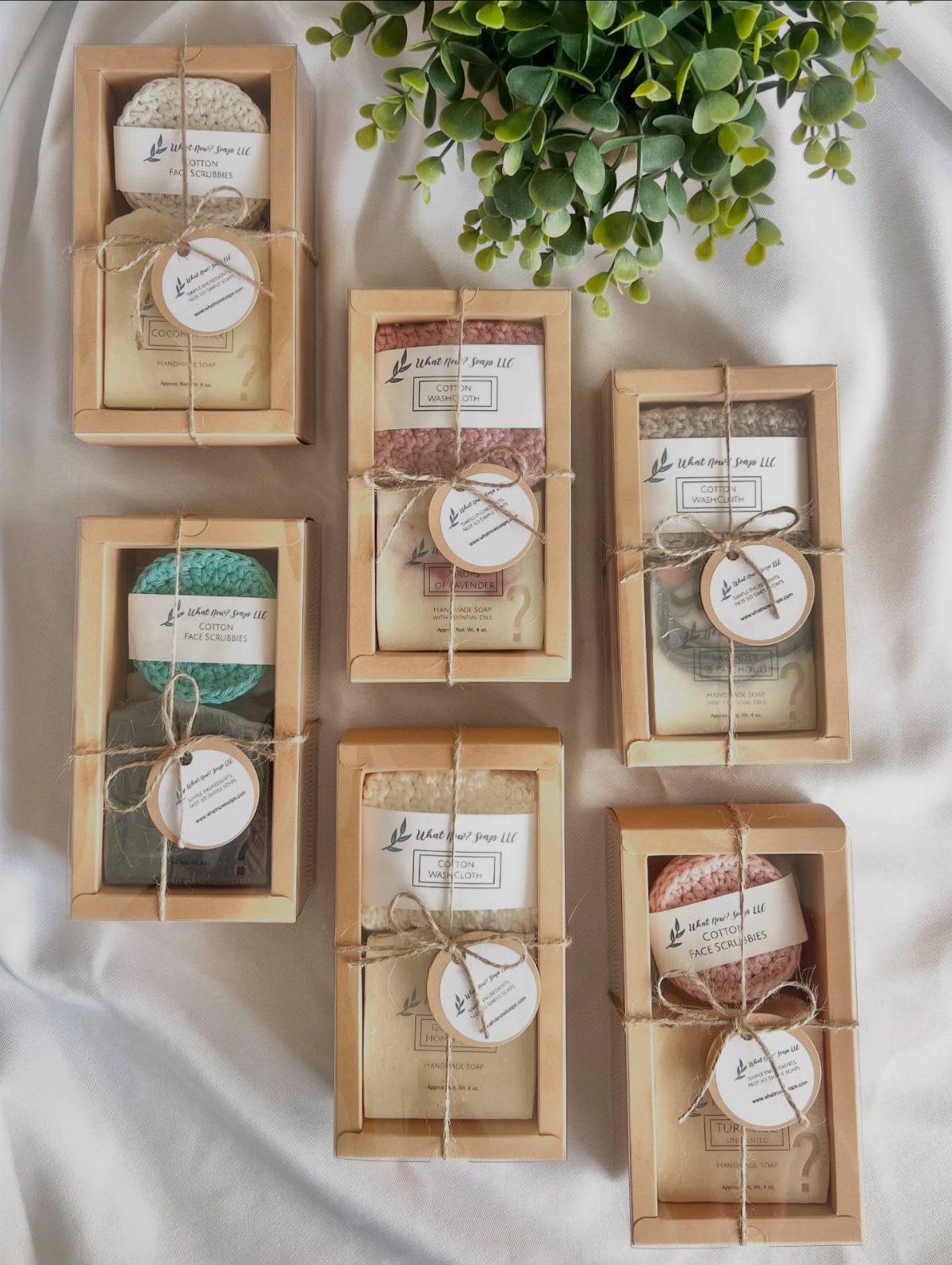Handmade soap bars in wooden boxes tied with twine and round labels.