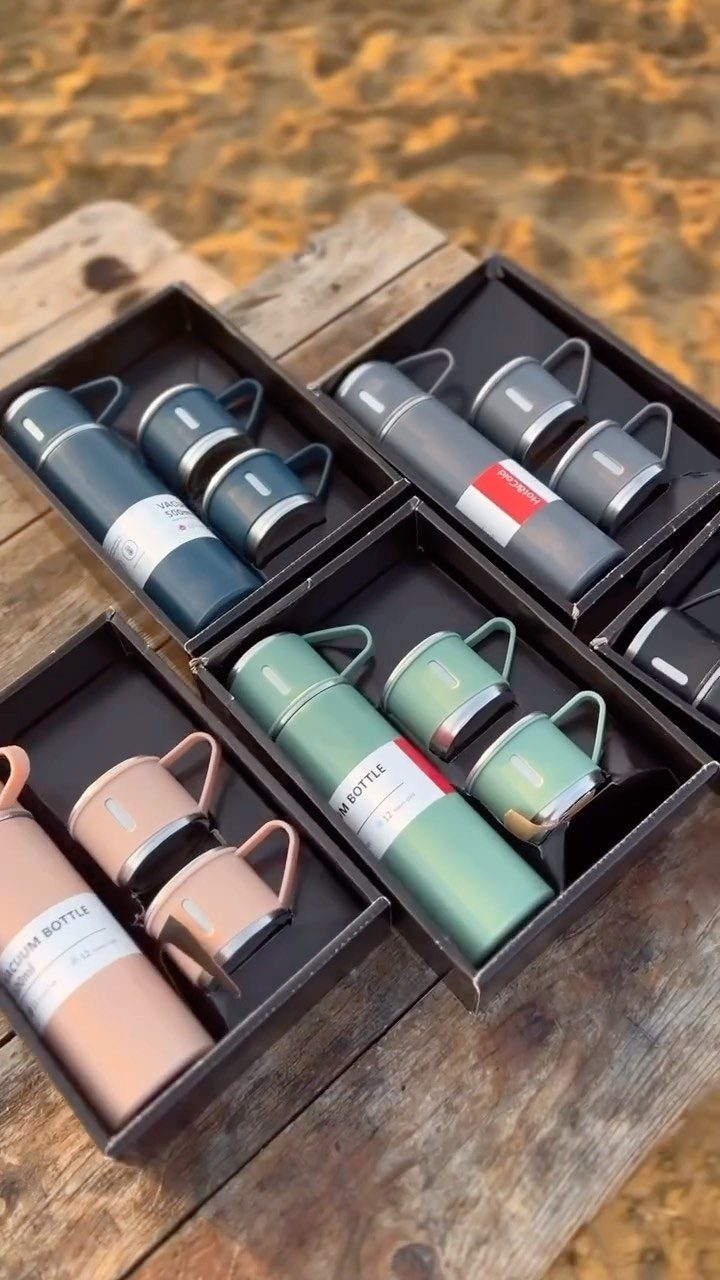 Gift sets of vacuum bottles and matching cups in various colors in black boxes.