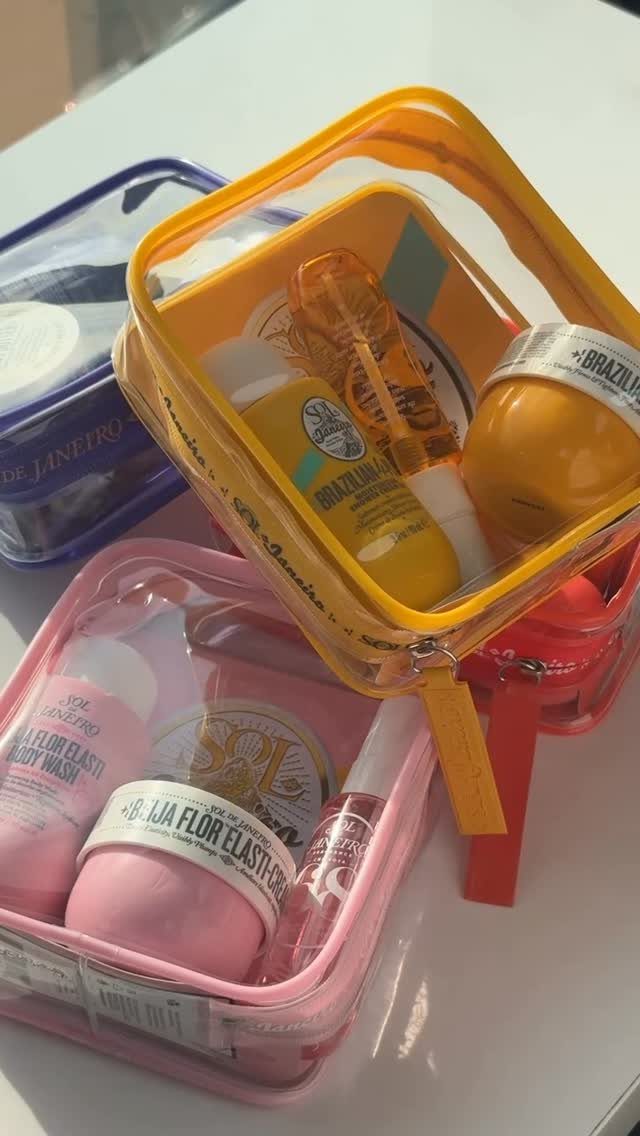 Three colorful transparent pouches filled with travel-sized skincare bottles and cosmetic jars.