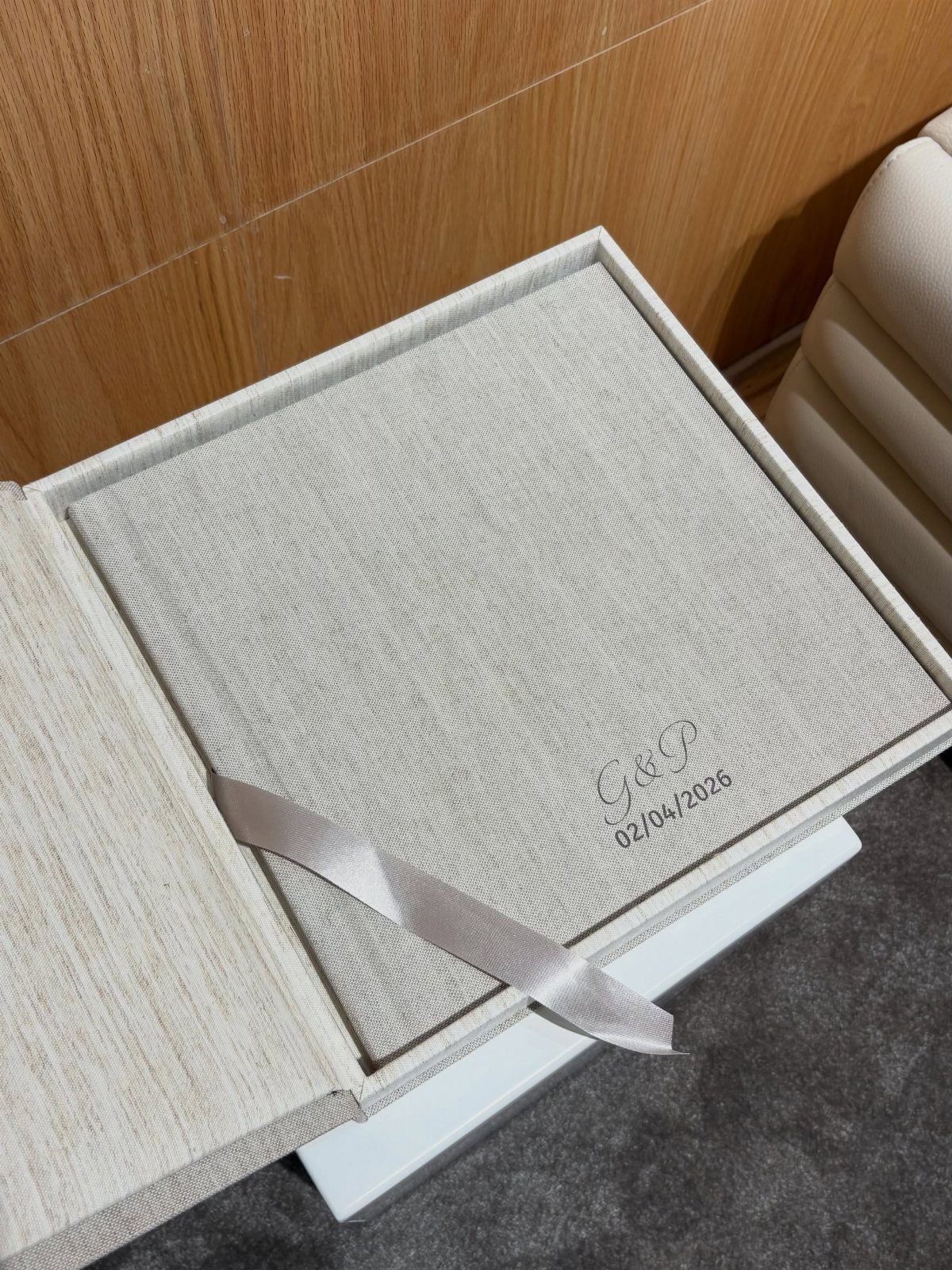 Linen-covered personalized anniversary album in a matching gift box with satin ribbon