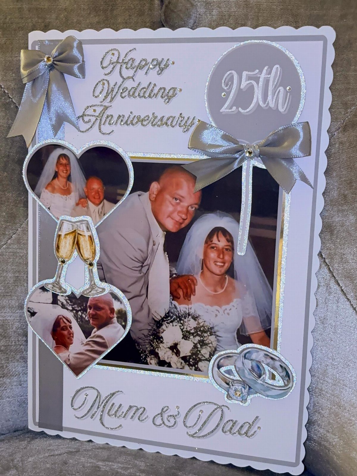 Handmade 25th wedding anniversary card with couple's photos and silver ribbon accents.