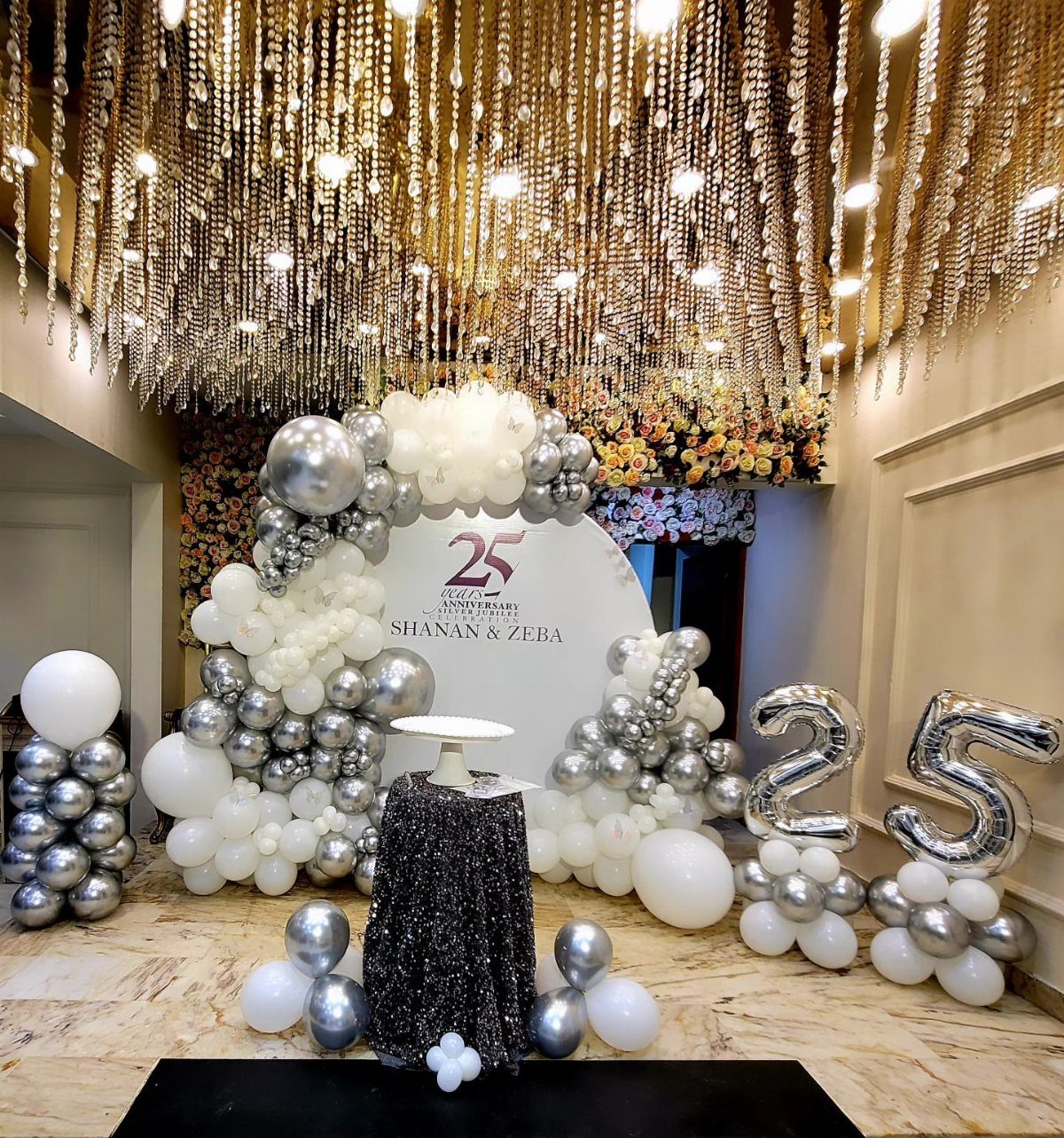 Silver and white balloon decorations with large 25 balloons for a silver anniversary party.