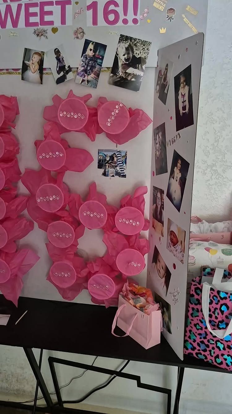Pink tissue paper number 16 with small cups and a photo board.