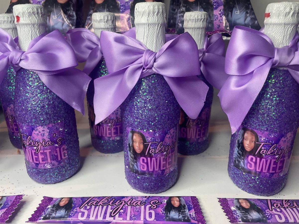 Purple glittery bottles with satin bows and custom Sweet 16 labels